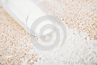 Milk spilled on carpet Stock Photo