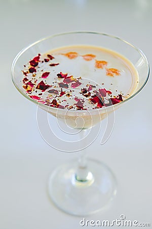 Milky rose cocktail with red petals Stock Photo