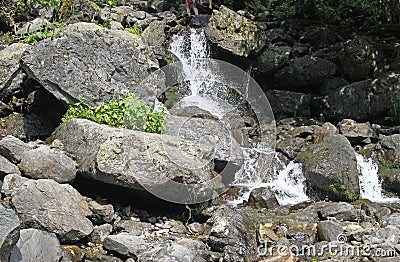 Milky waterfall at lake Ritsa Stock Photo