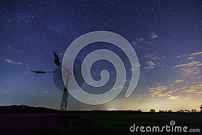 The milky way core rises above a windmill in central Germany Stock Photo