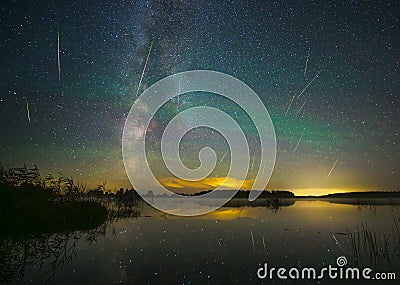 Milky way galaxy and perseid meteor shower. Green glow in the night sky. Stock Photo