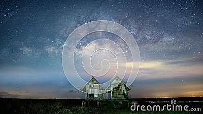 Milky way Galaxy with Twin houses at Pakpra village, Phatthalung Province Stock Photo