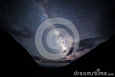 Milky Way illuminates the clouds in the mountains. Plateau Kara-Say (3.800 m.) Kyrgyzstan Stock Photo