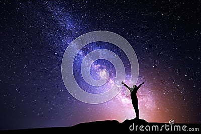 Milky Way. Night sky and silhouette of a standing girl Stock Photo