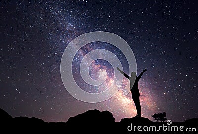 Milky Way. Night sky with stars and silhouette of a woman Stock Photo