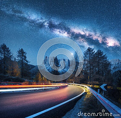 Milky Way over mountain road. Blurred car headlights Stock Photo