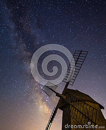 Milky Way rising behind historic windmill Stock Photo