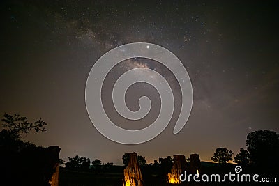 Milky way rising up parallel with ancient stone cliff Stock Photo