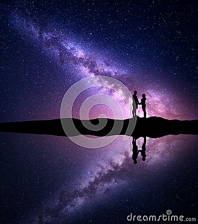 Milky Way with silhouette of people. Landscape with night sky Stock Photo