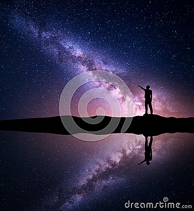 Milky Way. Silhouette of a standing man near the river Stock Photo