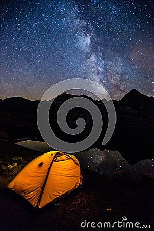 Milky way and tent in Ibon De Estanes, Pyrenees, Spain Stock Photo