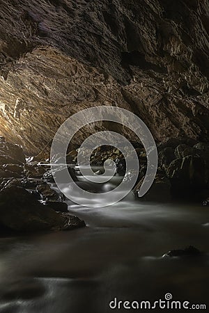 The Milky Way towering above the moonlight waterfall,Landscape of stream that flows from the cave to the waterfall with beautiful Stock Photo