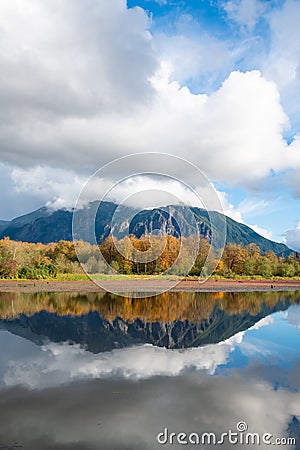 Mill Pond in Snoqualmie with reflection of Mount Si under towering clouds Stock Photo