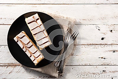 Millefoglie or French mille-feuille on white wooden table.Copy space Stock Photo