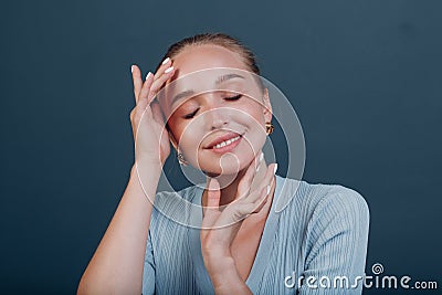 Millenial young woman blonde hair portrait doing face yoga self facebuilding massage for face skin Stock Photo