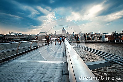 he Millenium Bridge and Saint Paul Cathedral on a stormy day in Editorial Stock Photo