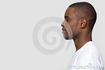 Millennial african man standing in profile isolated on white background Stock Photo