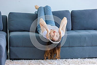 Asian young happy female wearing stereo wireless headset Stock Photo