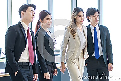 Millennial Asian young professional successful male female businessmen businesswomen in formal suit standing smiling side by side Stock Photo