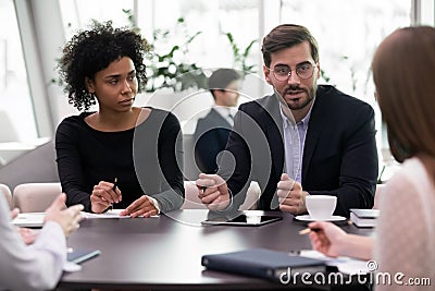 Millennial business man speaking to diverse team training brainstorming meeting Stock Photo