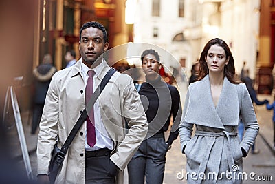 Millennial business people walking in a London street, front view, close up Stock Photo