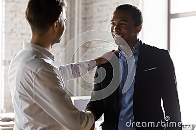 Caucasian boss handshake black employee greeting with success Stock Photo