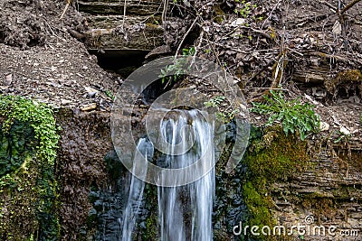 Millennial cold forest creek, little waterfall Stock Photo