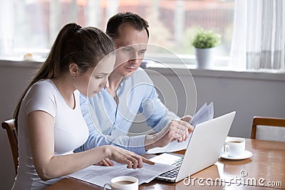 Millennial couple studying contract for new house before signing Stock Photo