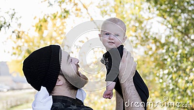 Millennial Dad Holding Baby Daughter Up Showing Affection Stock Photo