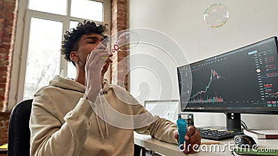 Millennial ethnic man relax trade online from home make soapbubbles Stock Photo