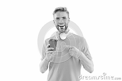 millennial guy with coffee in studio, pointing finger. photo of millennial guy with coffee. Stock Photo