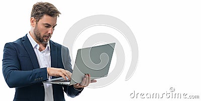 Millennial man working on laptop in studio. Hispanic man checking information on laptop, typing information on laptop Stock Photo