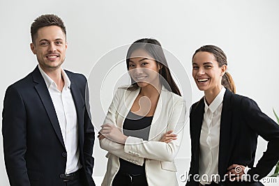 Millennial smiling multi-ethnic office professionals looking at Stock Photo