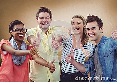 Millennial team giving thumbs up against brown background Editorial Stock Photo