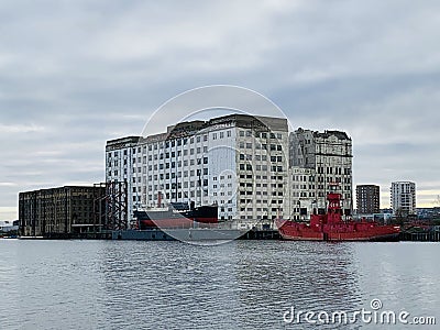 The Millennium Mills is a derelict turn of the 20th century flour mill in West Silvertown on the south side of the Royal Victoria Editorial Stock Photo