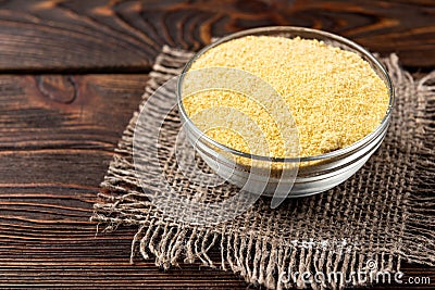 Millet flour on dark wooden. Stock Photo