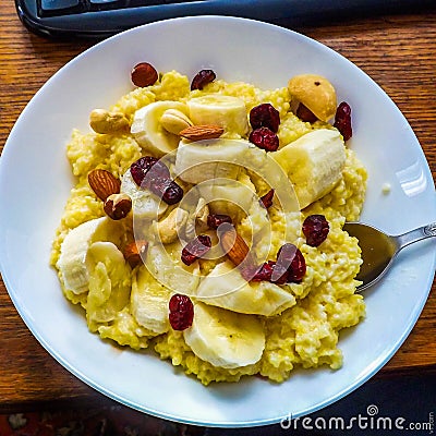 Millet porridge with cherries, bananas and nuts Stock Photo