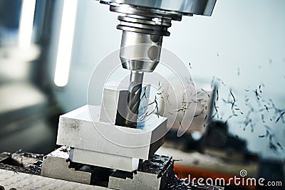 Milling cnc machine at metal work industry. Multitool precision machining. Shallow depth of view on shavings Stock Photo