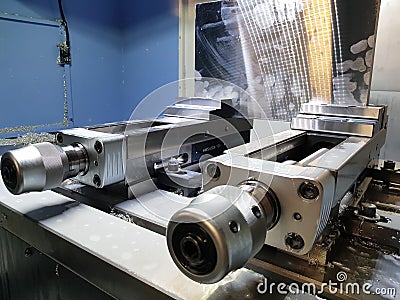 Milling machine clamps in metalworking process. Industrial CNC metal machining by vertical mill. Stock Photo