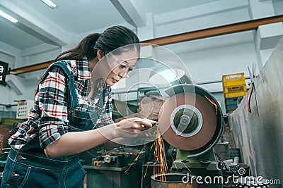 Milling machining worker using abrasive wheel tool Stock Photo