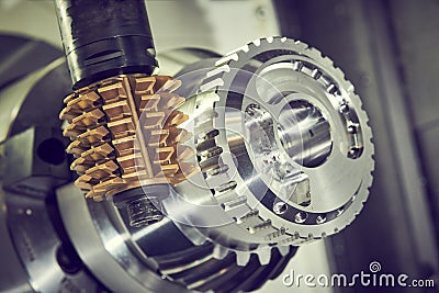 Cogwheel milling process. Industrial CNC metal machining by hobbing cutter mill Stock Photo