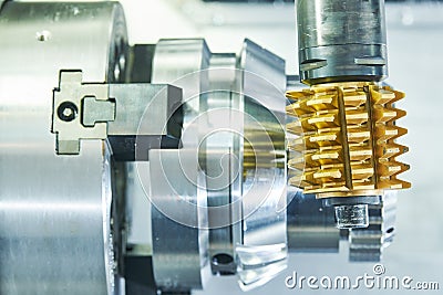 Cogwheel milling process. Industrial CNC metal machining by hobbing cutter mill Stock Photo