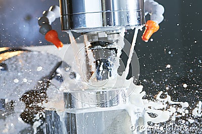 Milling process. precision CNC machining by vertical mill with coolant Stock Photo