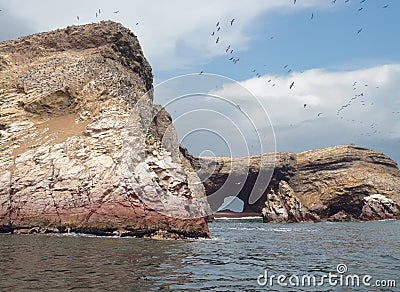 Millions of birds make home at the rock cliffs, and deposit guano at Ballestas Islands Peru Stock Photo