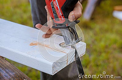 Milwaukee power tools Cutting of wood using a electric jigsaw sawdust Editorial Stock Photo