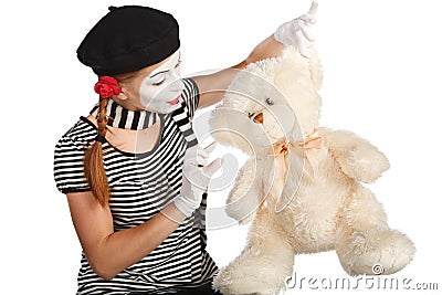 Mime comedian talking with teddy bear Stock Photo