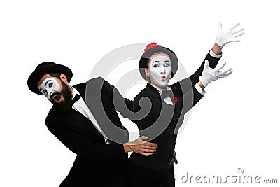 Mime holding another one up and running Stock Photo