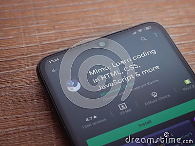 Mimo - Learning coding app play store page on the display of a black mobile smartphone on wooden background Editorial Stock Photo