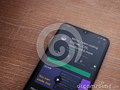 Mimo - Learning coding app play store page on the display of a black mobile smartphone on wooden background Editorial Stock Photo
