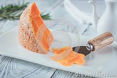 Mimolette cheese on white plate Stock Photo